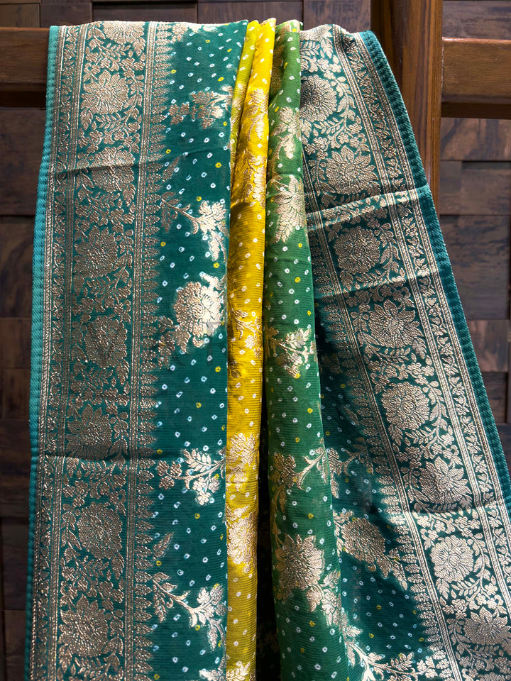 Green and gold patterned fabric draped over a wooden surface