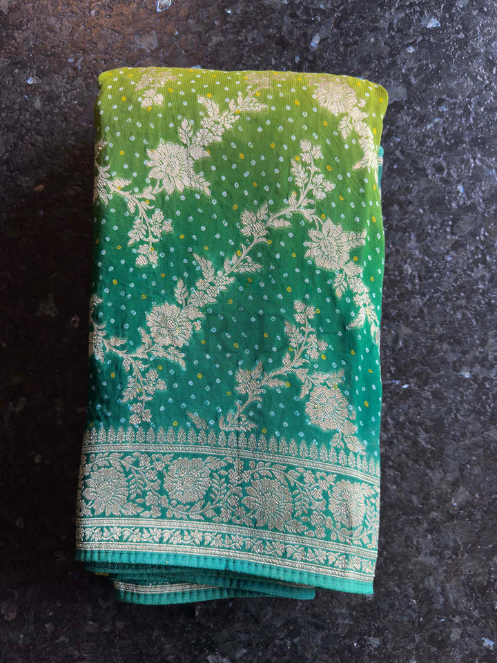 Green fabric with floral patterns on a dark surface