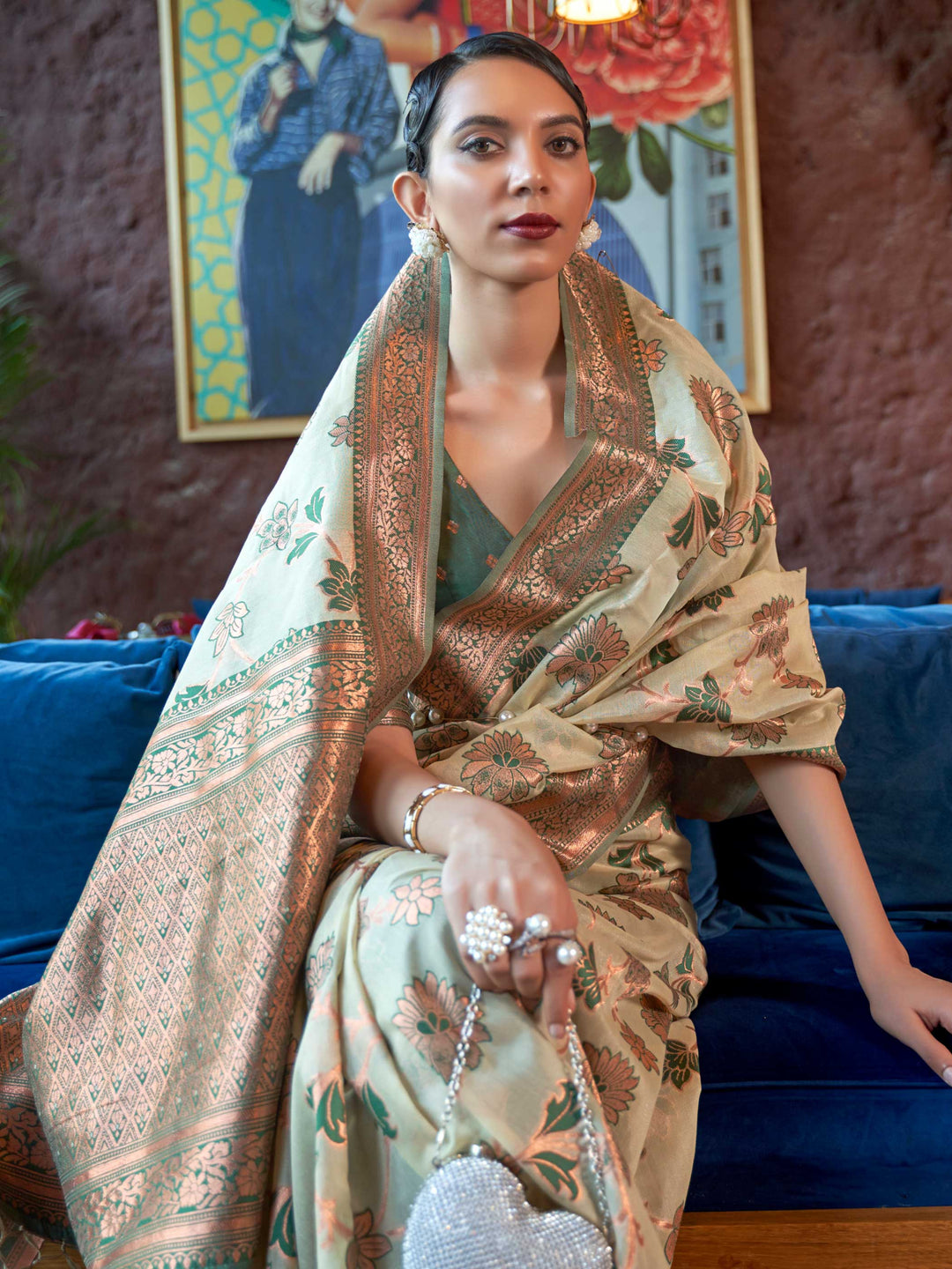 Elegant Green Organza Silk Saree adorned with Intricate Zari Weaving and a Heavy Border, offering a Luxurious Drape—ideal for those seeking Authentic Ethnic Wear with a Contemporary Touch. 
