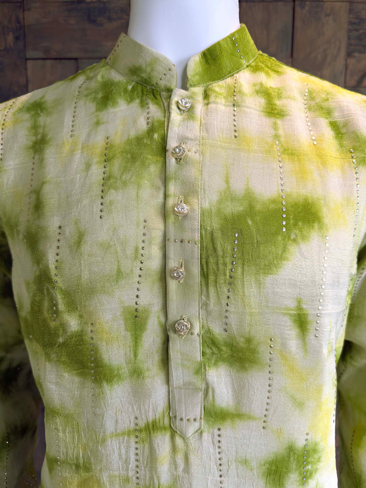 Close up of Lime Green Tie-Dye Kurta showing Vertical Sequin Lines and Crystal Buttons. Green and yellow tie-dye shirt on a mannequin against a wooden background