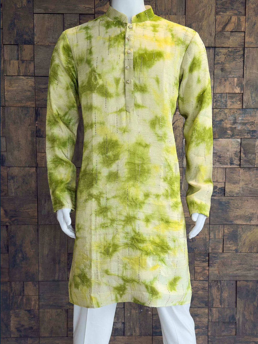 Side view of Designer Tissue Kurta with Sequin Pinstripes and Mandarin Collar. Green tie-dye kurta with white pants on a wooden paneled background