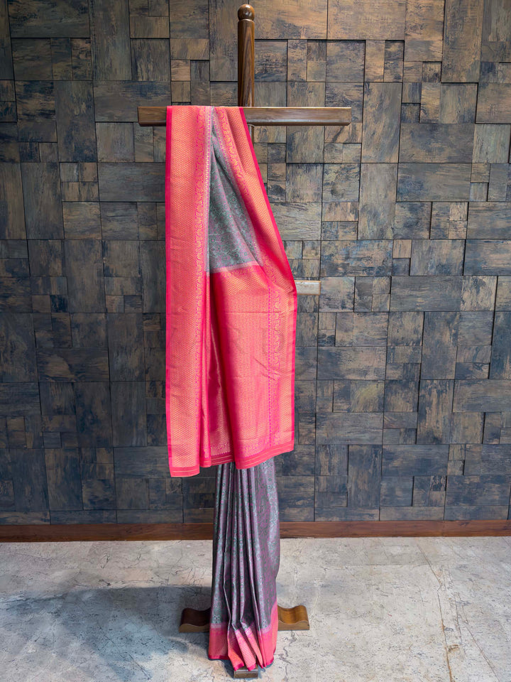 Full drape view of Steel Grey Tanchoi Silk saree with Hot Pink border on mannequin.