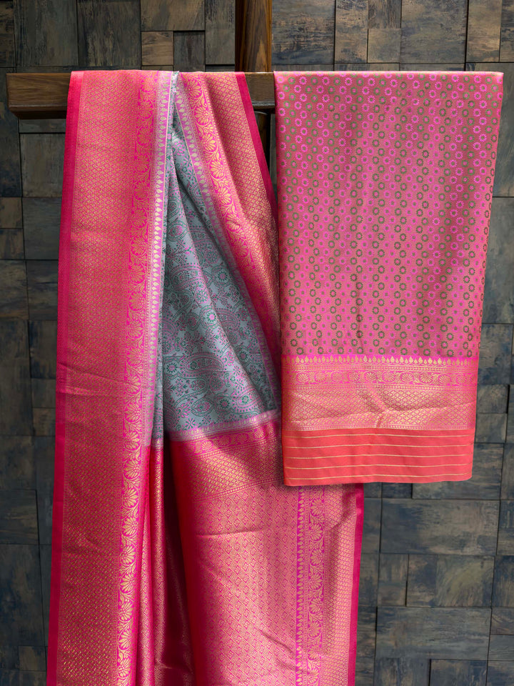 Saree with matching Hot Pink blouse piece featuring small zari buttis.