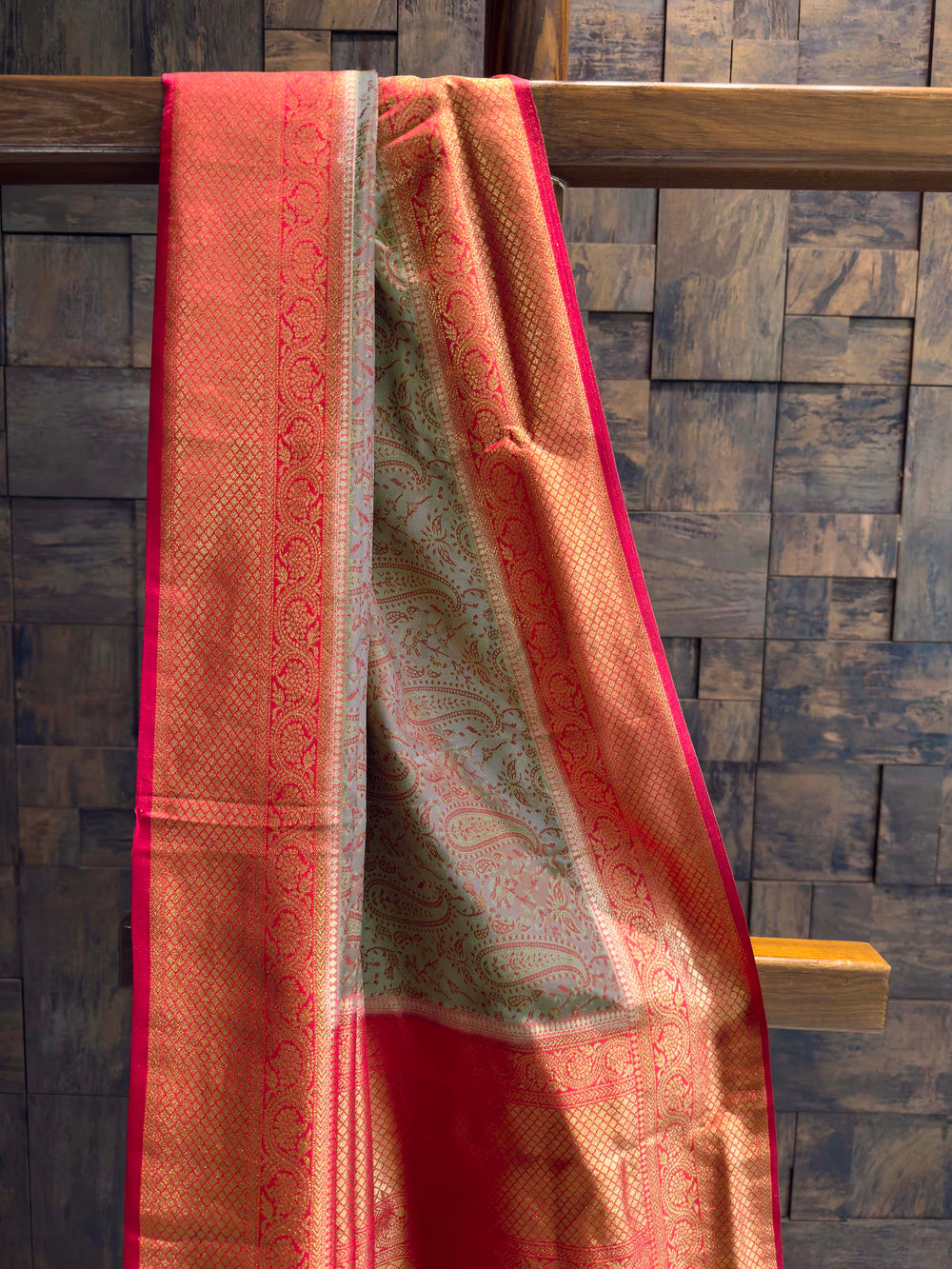 Close-up of the grey satin body showing red woven paisley motifs.
