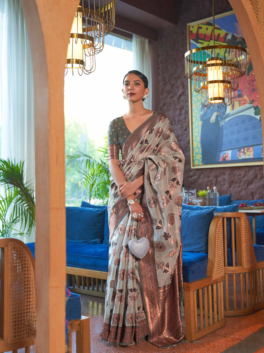 Grey Shimmer Organza Saree with Copper Zari Weaving and Contrast Border, featuring Exquisite Floral Jangla Design—a perfect blend of Traditional Craftsmanship and Modern Elegance for Festive Occasions. 
