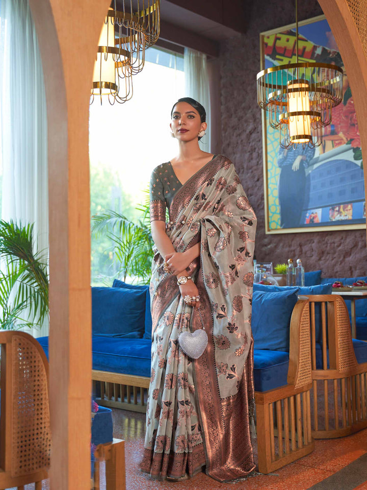 Grey Shimmer Organza Saree with Copper Zari Weaving and Contrast Border, featuring Exquisite Floral Jangla Design—a perfect blend of Traditional Craftsmanship and Modern Elegance for Festive Occasions. 
