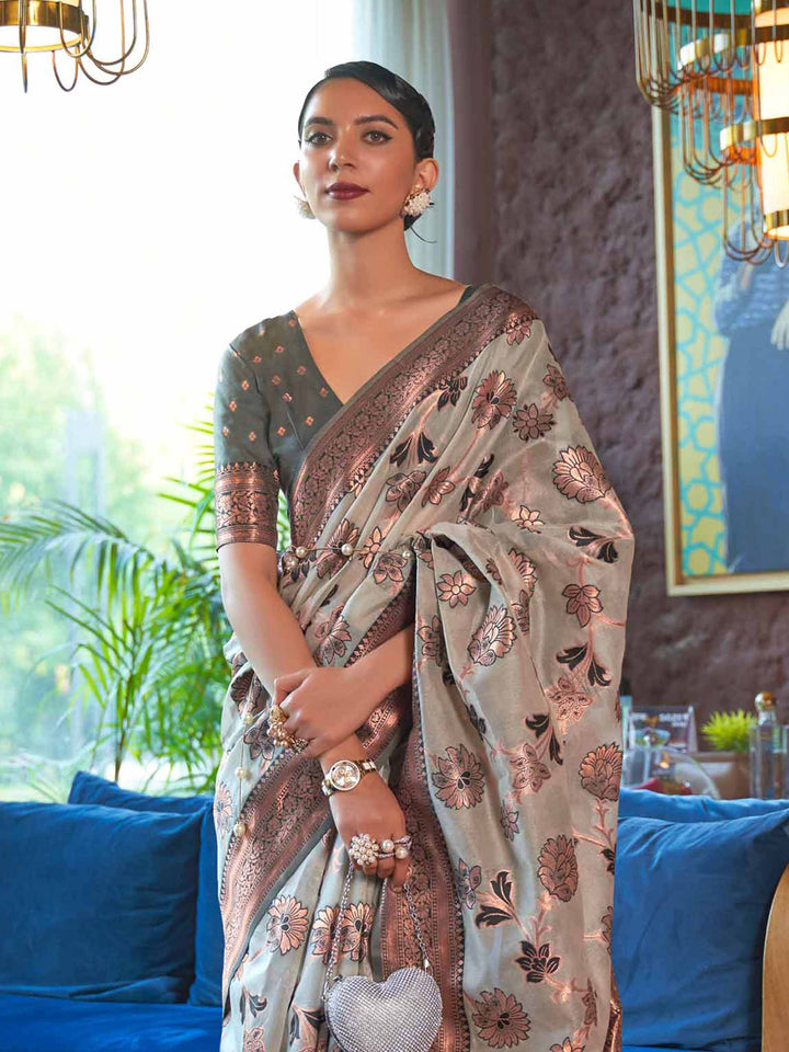 Designer Grey Shimmer Organza Saree featuring Intricate Copper Zari Weaving and a Darker Contrast Border, providing an Elegant Silhouette—perfect for Wedding Ceremonies and High-End Gatherings. 
