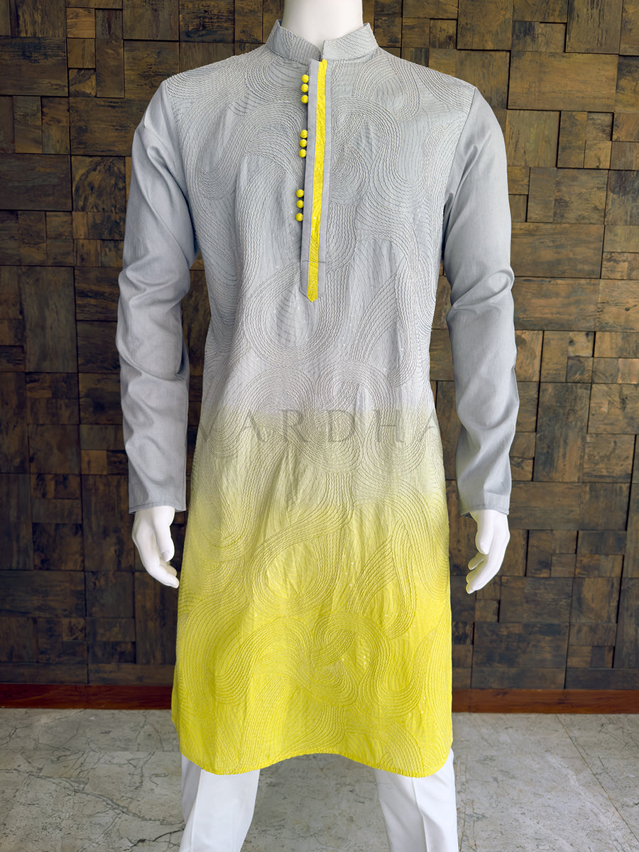 Gray and yellow kurta on a mannequin against a wooden paneled wall. Close-up of the grey and lemon yellow ombre men's festive kurta showcasing the intricate textured wavy threadwork and a bright yellow contrast button placket.