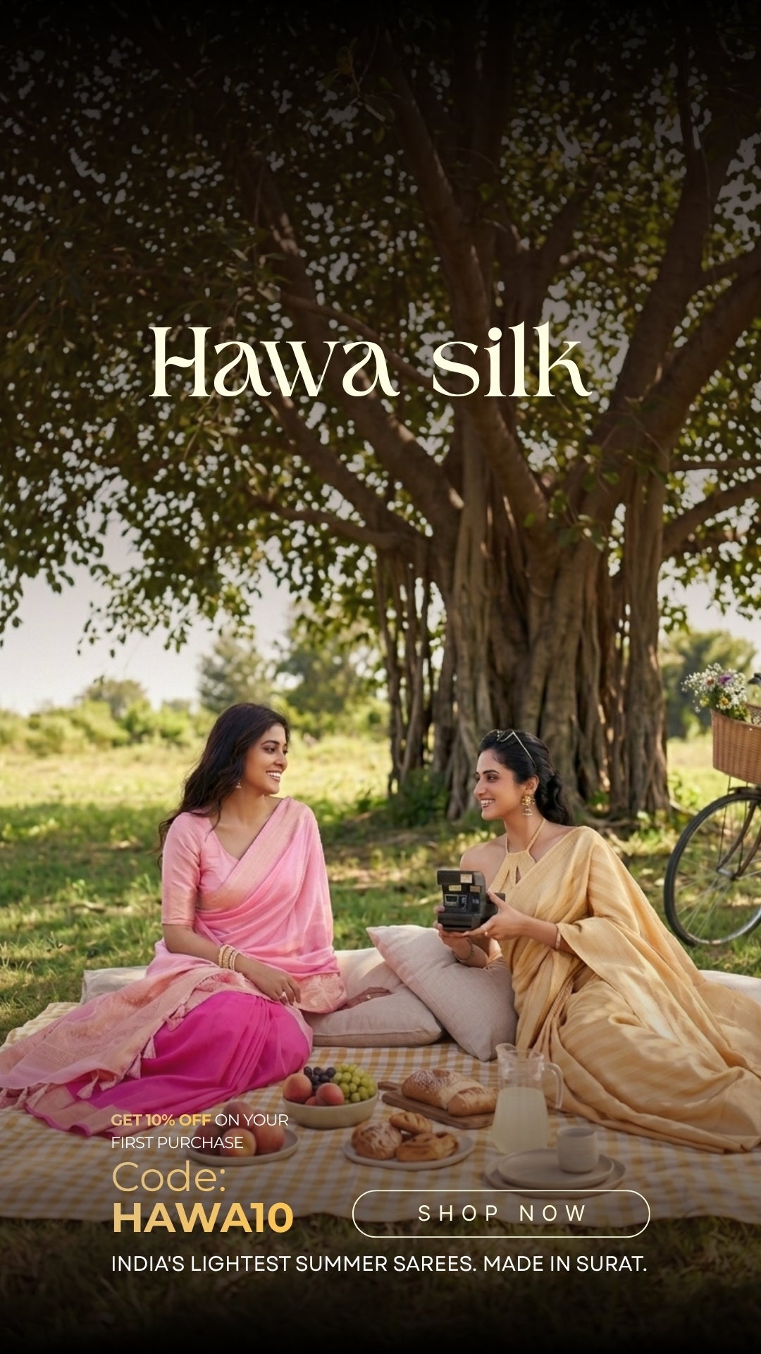 Two women in traditional sarees sitting under a tree with Hawa silk. Two women in traditional silk sarees sitting under a tree with a picnic, promoting Hawa Silk. Shop this Feathersoft Lightweight sarees from House of Vardha.