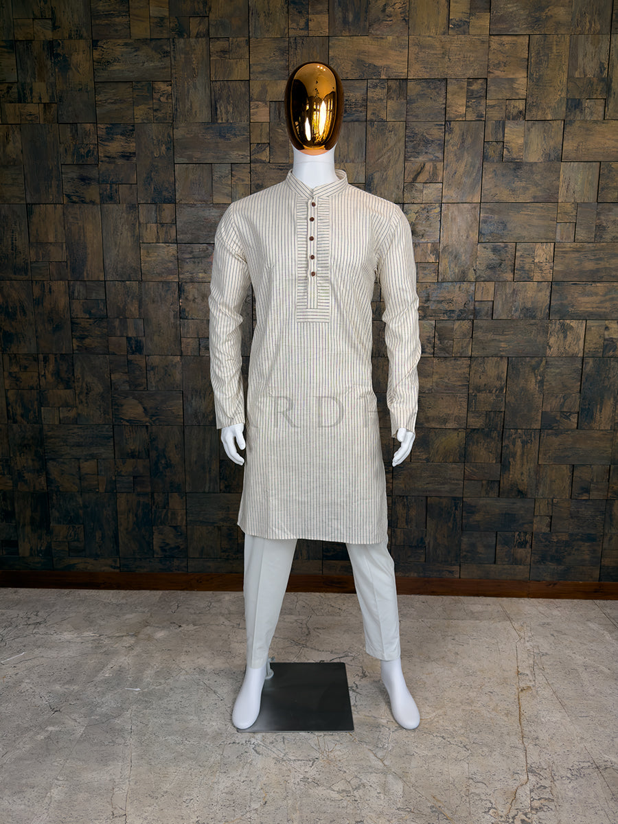 Mannequin wearing a light-colored kurta with a wooden paneled wall background