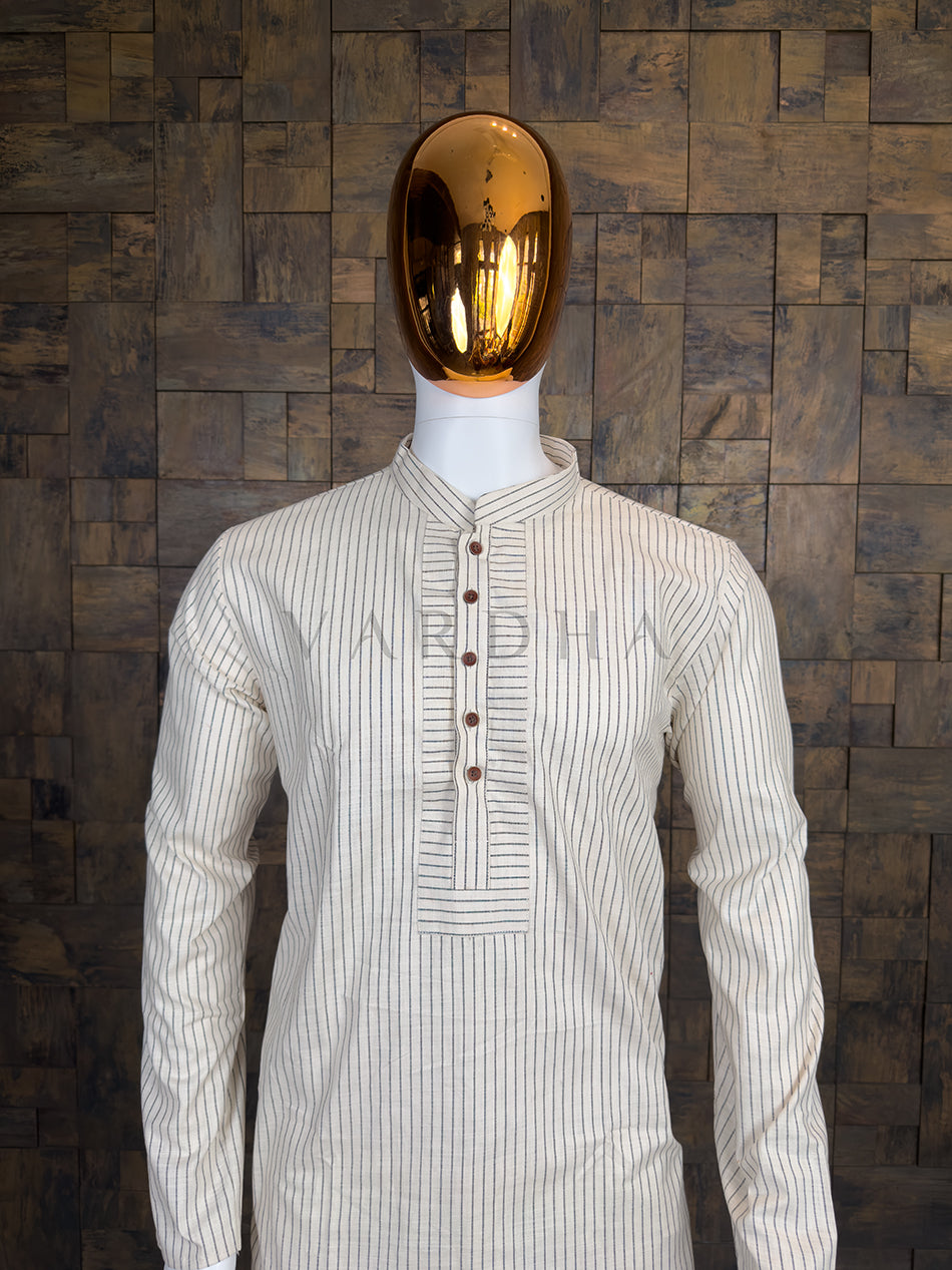 Mannequin wearing a white striped shirt against a wooden paneled wall.