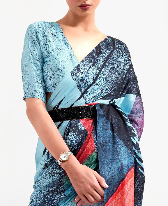 Chic ice blue and ebony red digital printed crepe saree with Bollywood-inspired drape and floral designs for festive occasions.