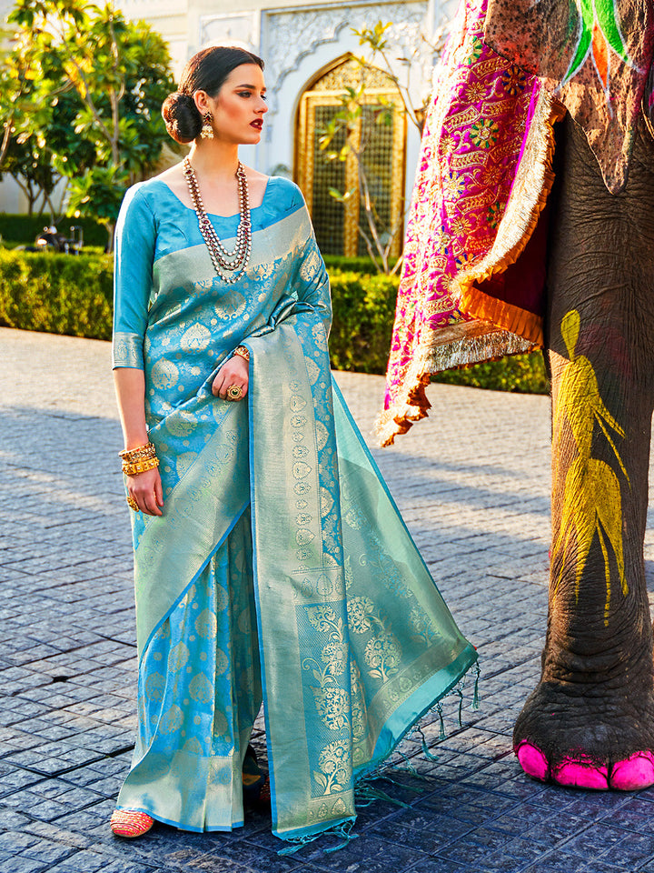 Teal Blue–Green bridal kanjivaram saree with gold zari motifs and festive pallu styling. Classic Teal Blue–Green silk saree featuring woven jacquard zari and traditional pallu elegance.