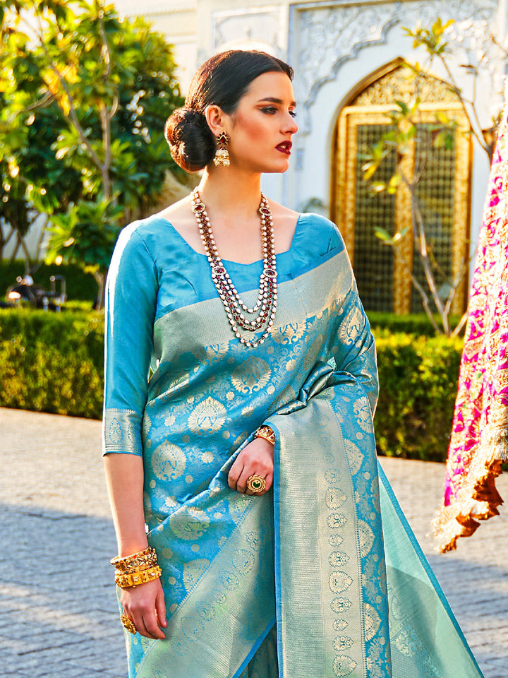 Teal Blue–Green kanjivaram silk drape styled for receptions, varmala, and wedding rituals. Glossy silk base in Teal Blue–Green with gold accents and woven border flair.