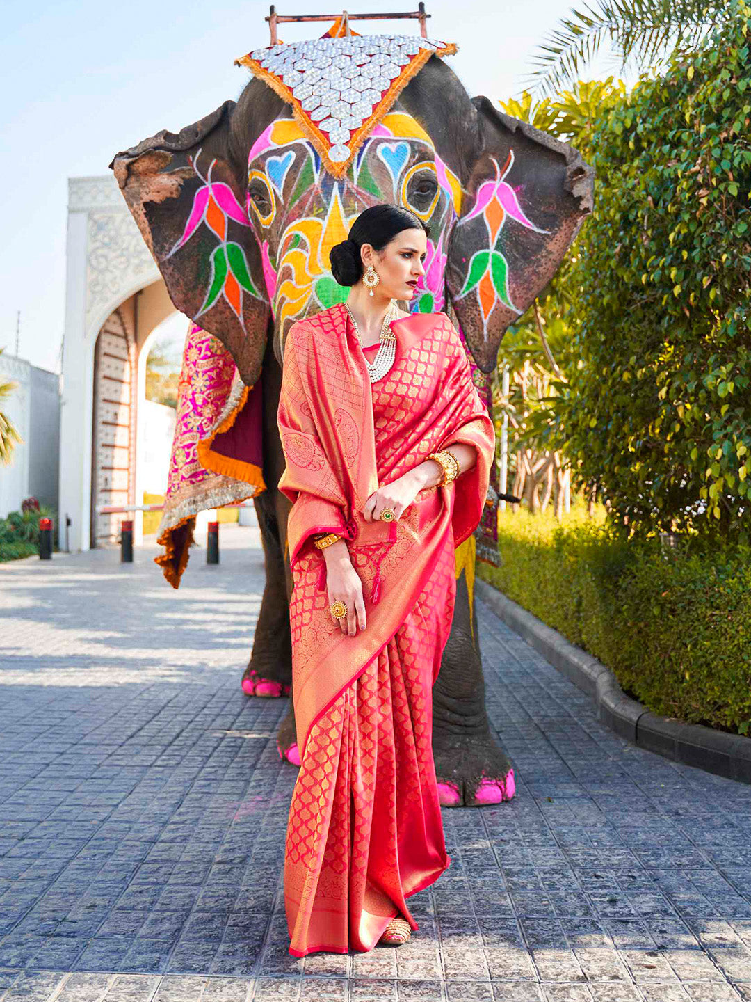 Traditional wedding saree in Magenta–Gold featuring rich zari work and heritage charm. Magenta–Gold silk saree with zari woven paisley and floral motifs, bridal ceremony ready.