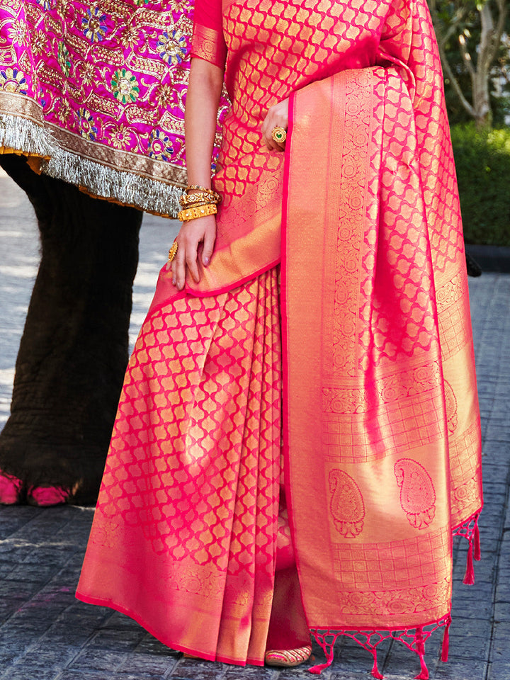 Opulent kanjivaram weave in Magenta–Gold silk, styled with contrast blouse and pallu. South Indian inspired bridal saree in Magenta–Gold with glossy texture and rich borders.