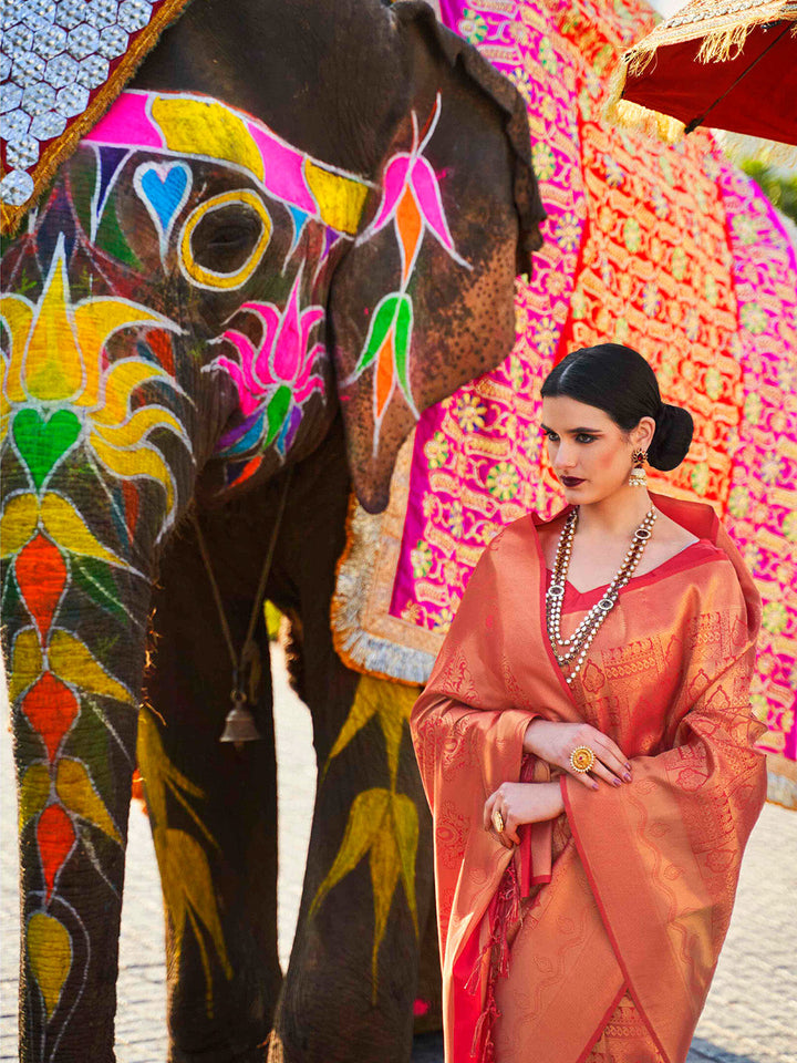 Traditional wedding saree in Maroon–Gold featuring rich zari work and heritage charm. Maroon–Gold silk saree with zari woven paisley and floral motifs, bridal ceremony ready.