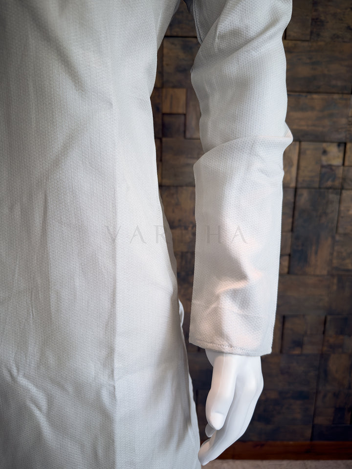 Grey lab Kurta on a wooden background. Close-up of a designer Light Grey kurta showing the extended chest placket with traditional fabric button loops and rustic wooden-style buttons.