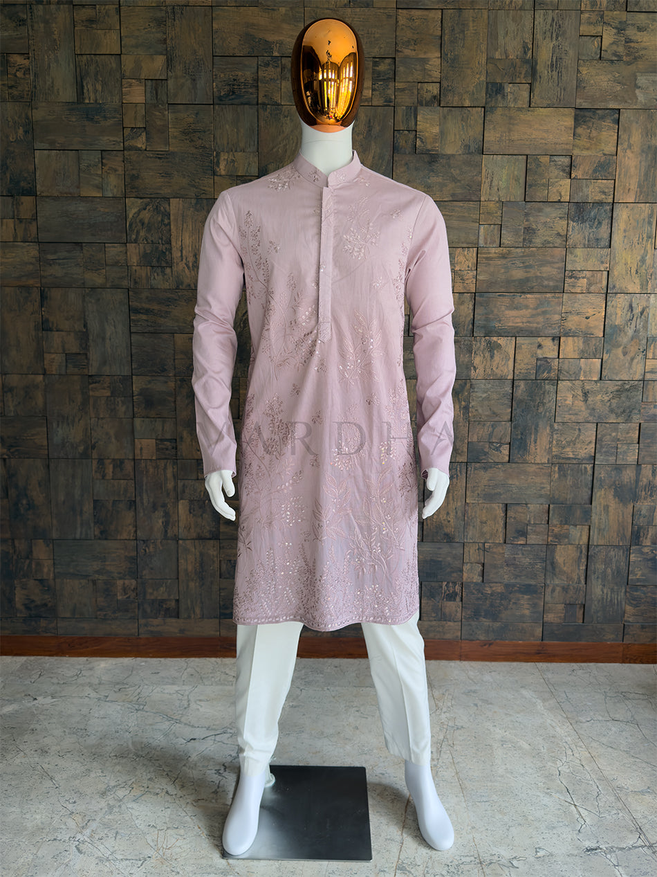 Front view of a man wearing a House of Vardha light lilac viscose kurta featuring delicate floral embroidery and subtle sequin embellishments. Perfect men's ethnic wear for day weddings and festive celebrations.Full-length view of the elegant light lilac designer kurta paired with white pyjama bottoms, showcasing the sophisticated and balanced silhouette for grand occasions.