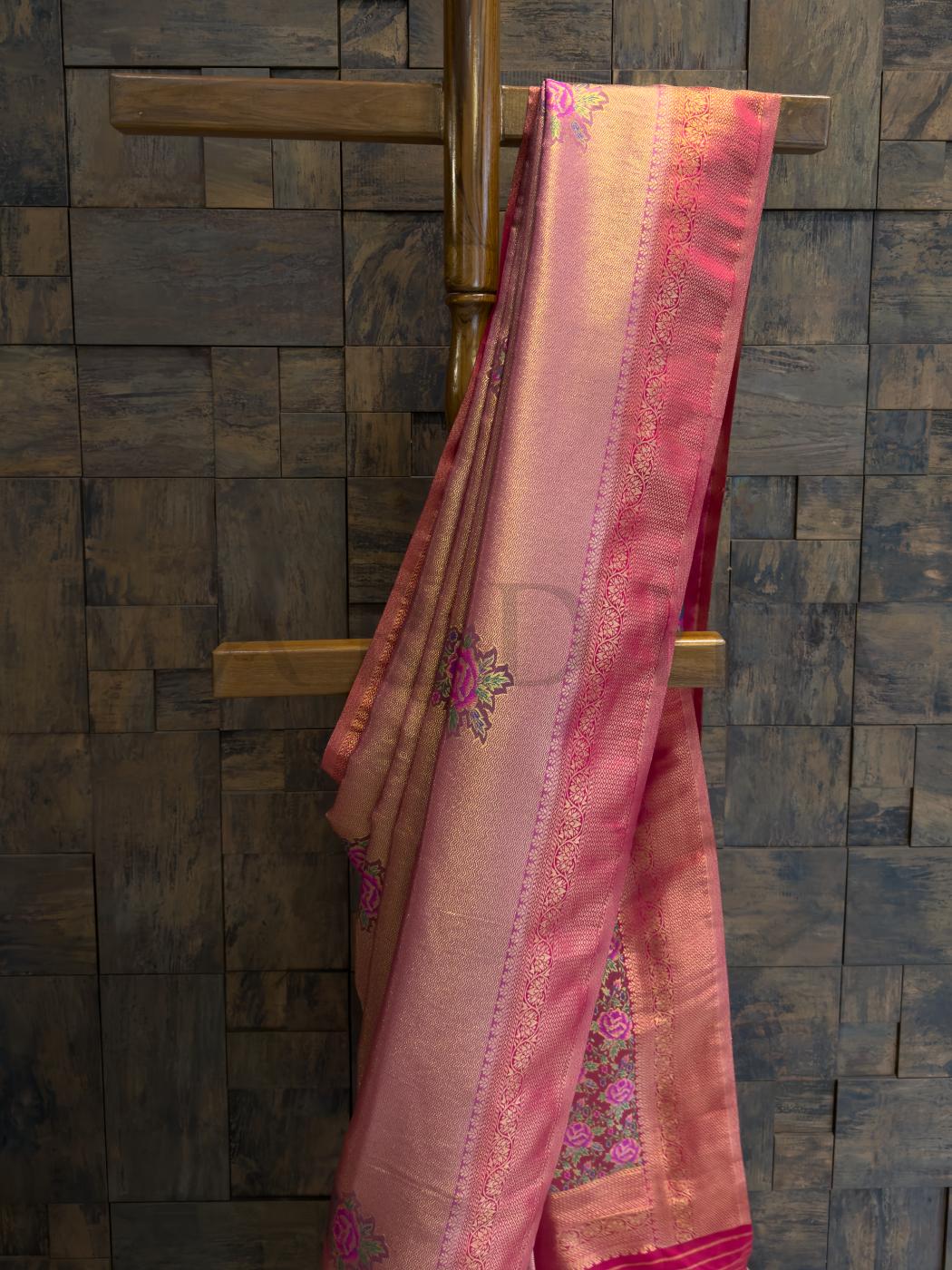  Soft art silk saree pleats in lac pink with zari accents, perfect for traditional festivities and wedding wear., Pallu showcasing colorful floral kalamkari artistry framed in luminous golden thread work