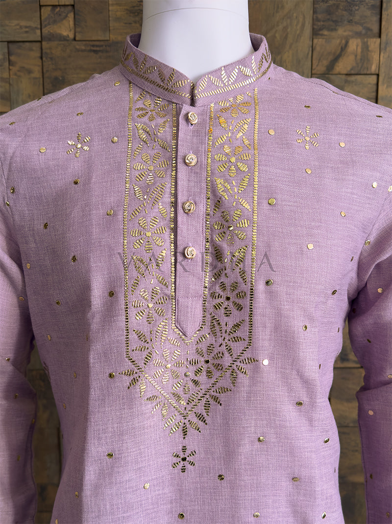 Premium lilac ethnic kurta with gold mukaish embellishments ideal for weddings and festivals kurta with gold embroidery on a mannequin against a wooden background