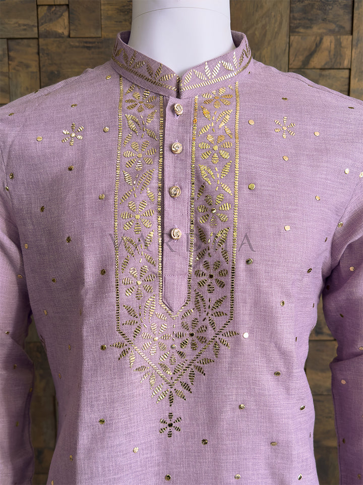 Premium lilac ethnic kurta with gold mukaish embellishments ideal for weddings and festivals kurta with gold embroidery on a mannequin against a wooden background