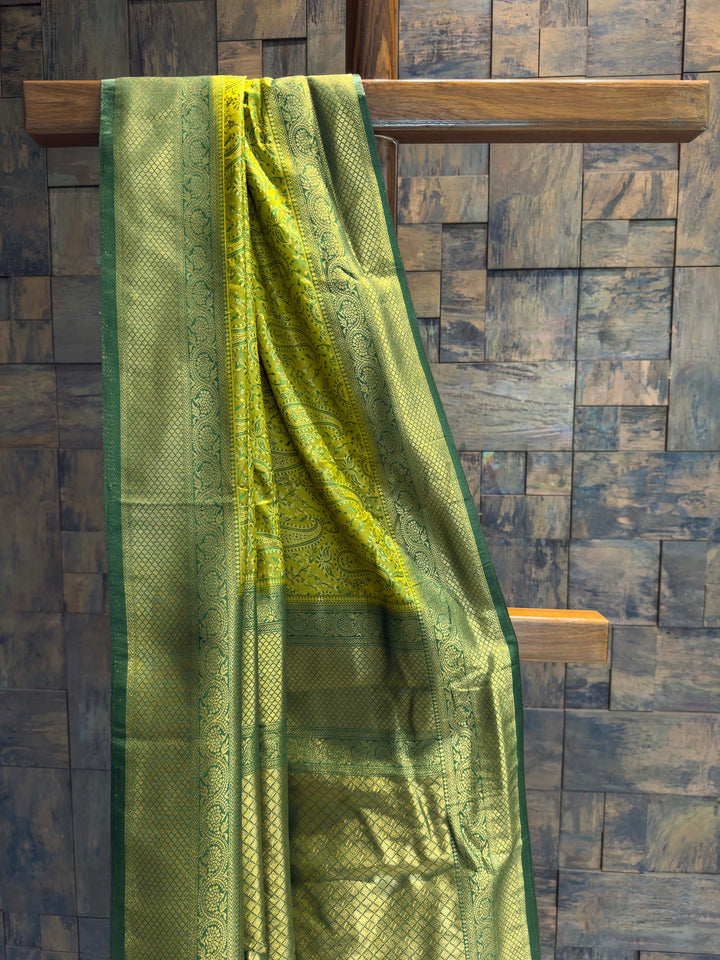 Close-up of the chartreuse satin body showing woven paisley motifs.