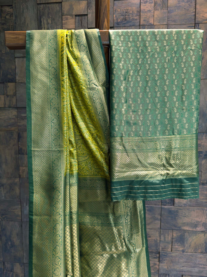 Saree with matching Bottle Green blouse piece featuring all-over zari paisley buttis.