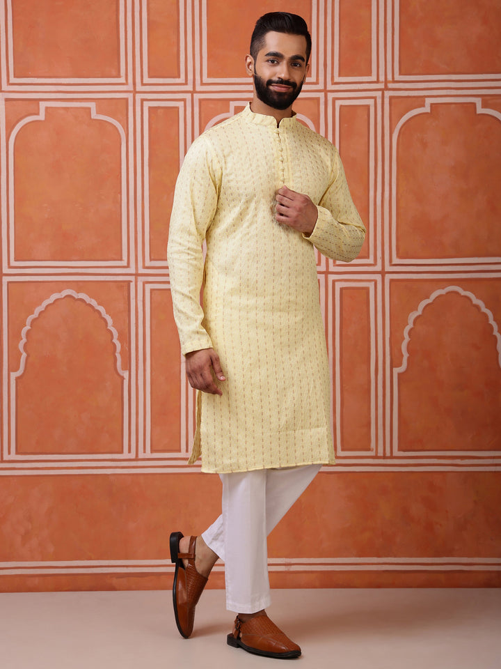 Close-up of the fine dobby weave and classic fabric-covered potli buttons on a men's yellow kurta