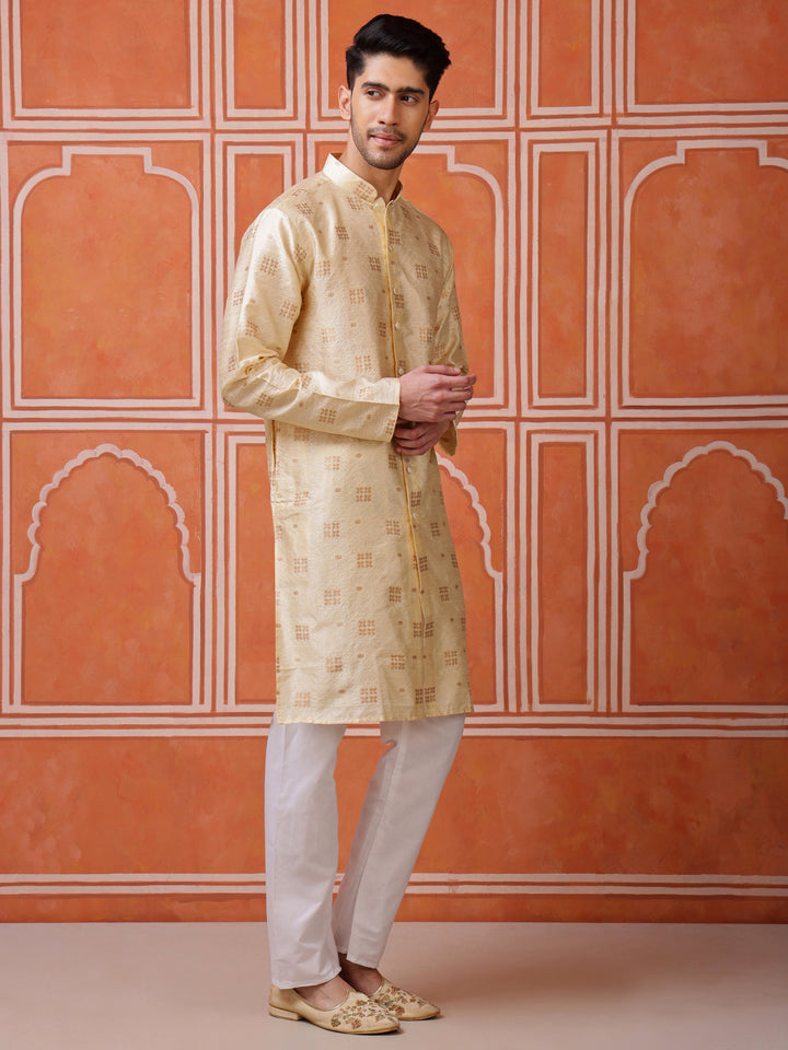 Close-up of the lustrous silk blend fabric and the elegant goldish-brown woven buti design