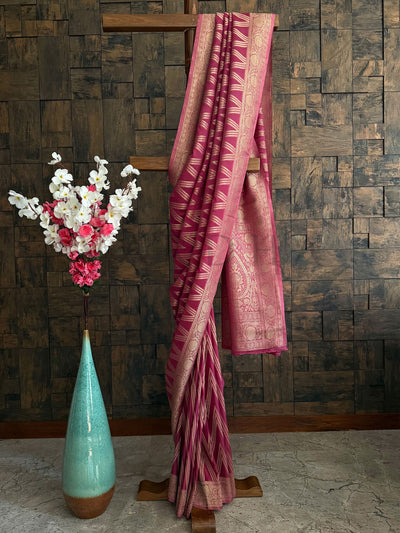 Rose pink soft georgette saree with intricate golden zari pallu for traditional occasions.