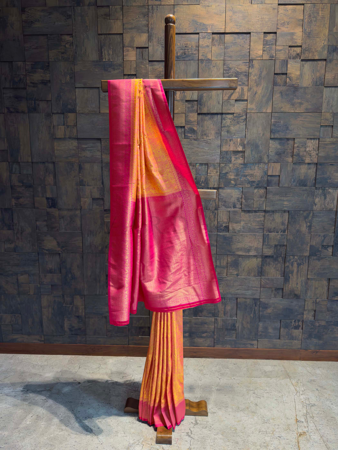 Full drape view of Mango Yellow Tanchoi Satin Silk saree with Pink border on mannequin.