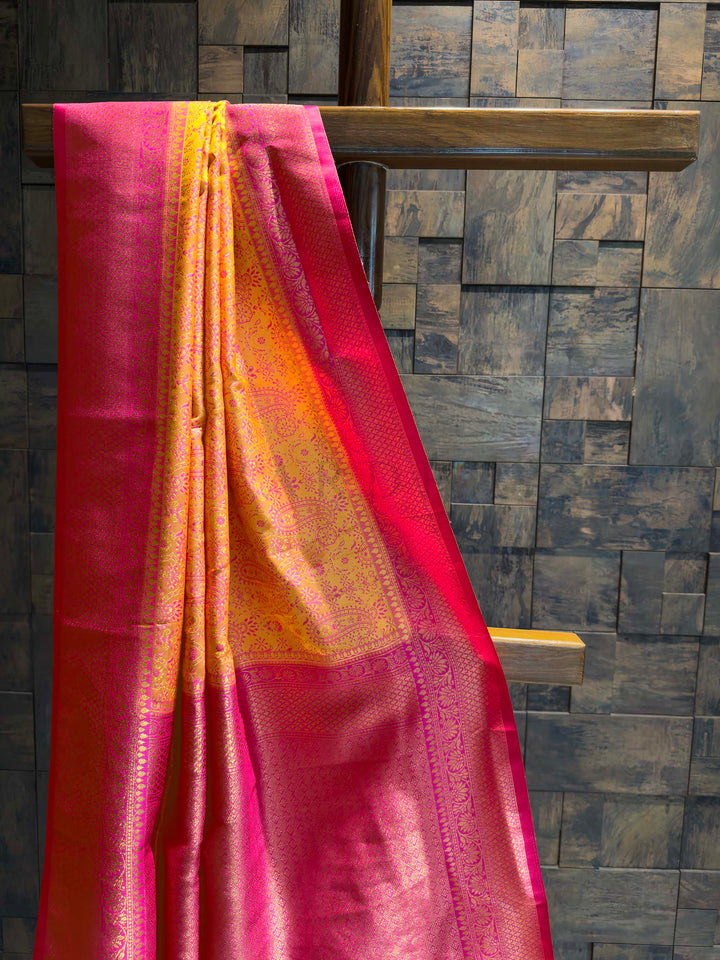 Close-up of the yellow-orange satin body showing pink woven paisley motifs.