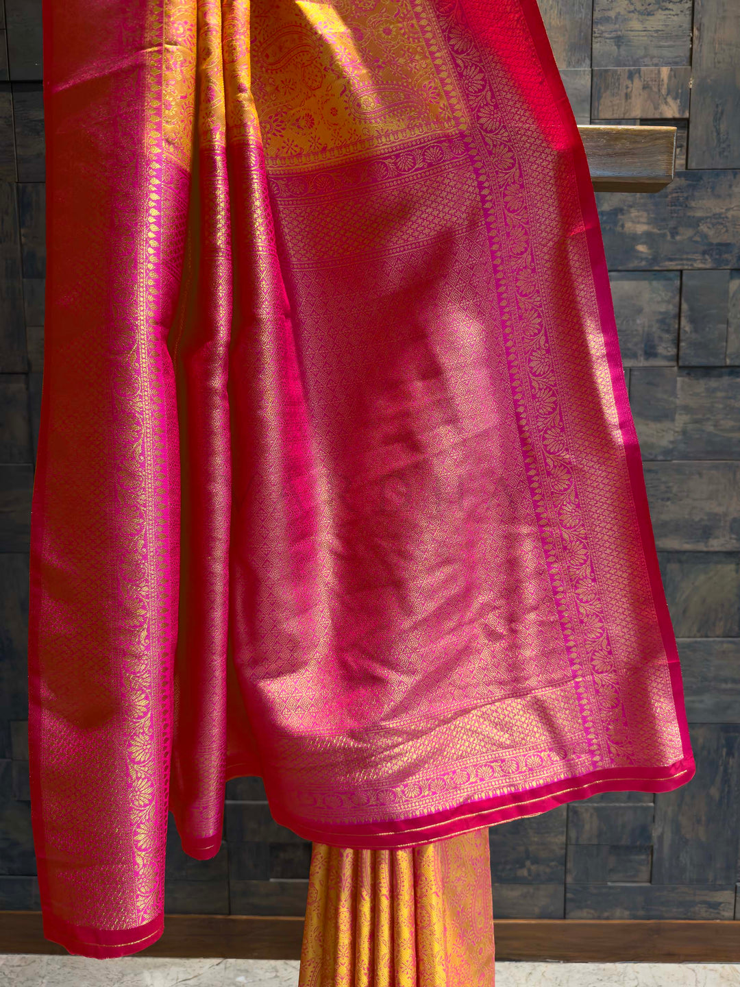 Detail shot of the Hot Pink Gold Zari border contrasting with the yellow body.