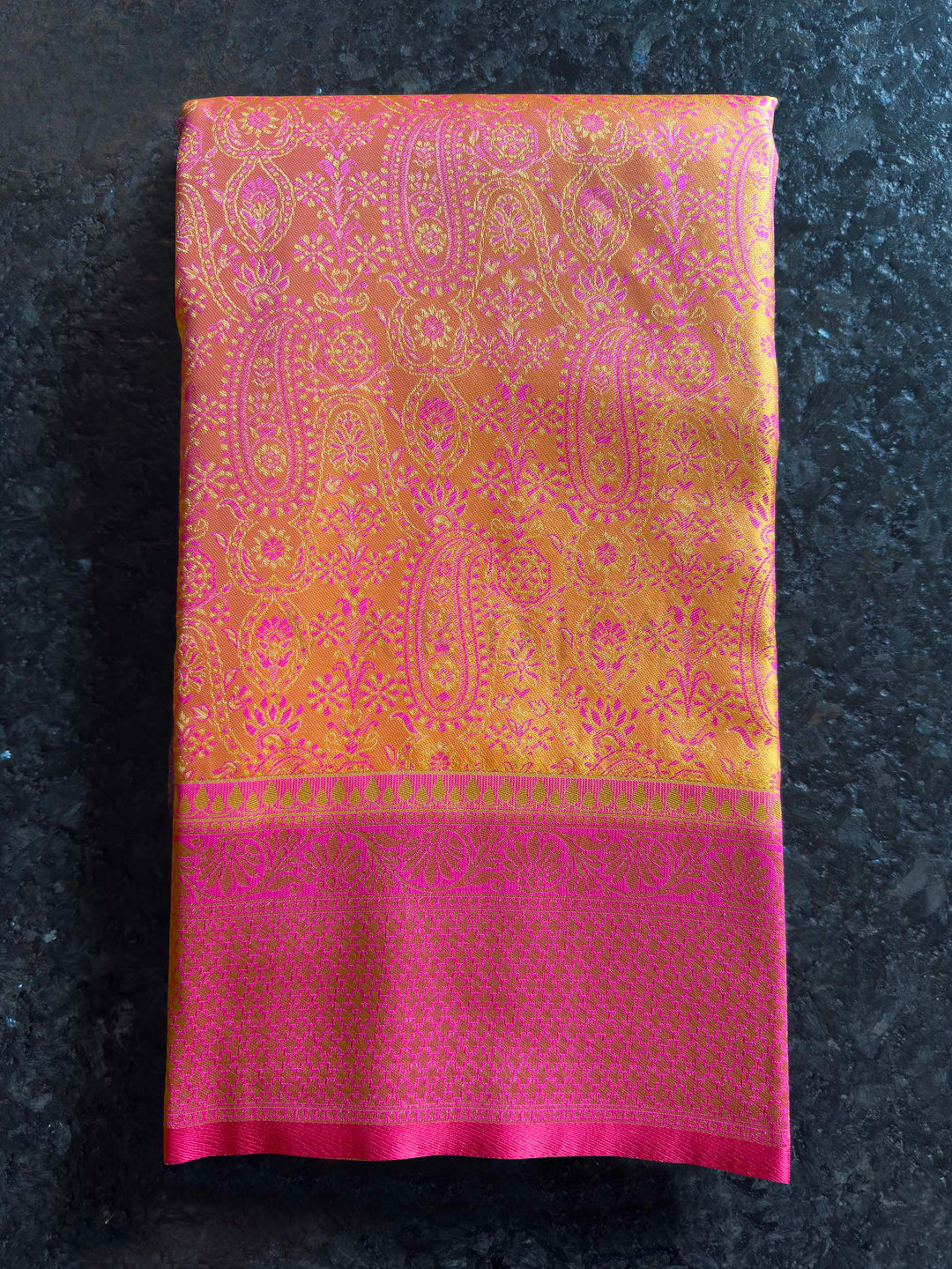 Folded view highlighting the sheen and intricate Tanchoi weave of the satin fabric.