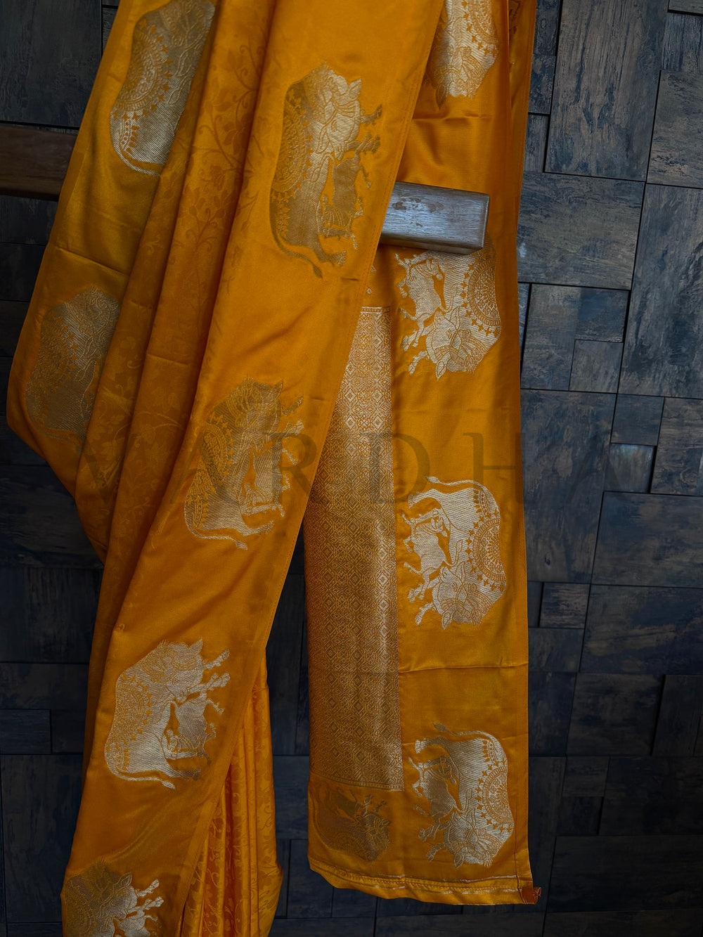 Festive satin saree in deep orange hue with intricate zari woven elephant pattern.

Elegant mustard-orange satin saree with traditional elephant design and silky finish.

