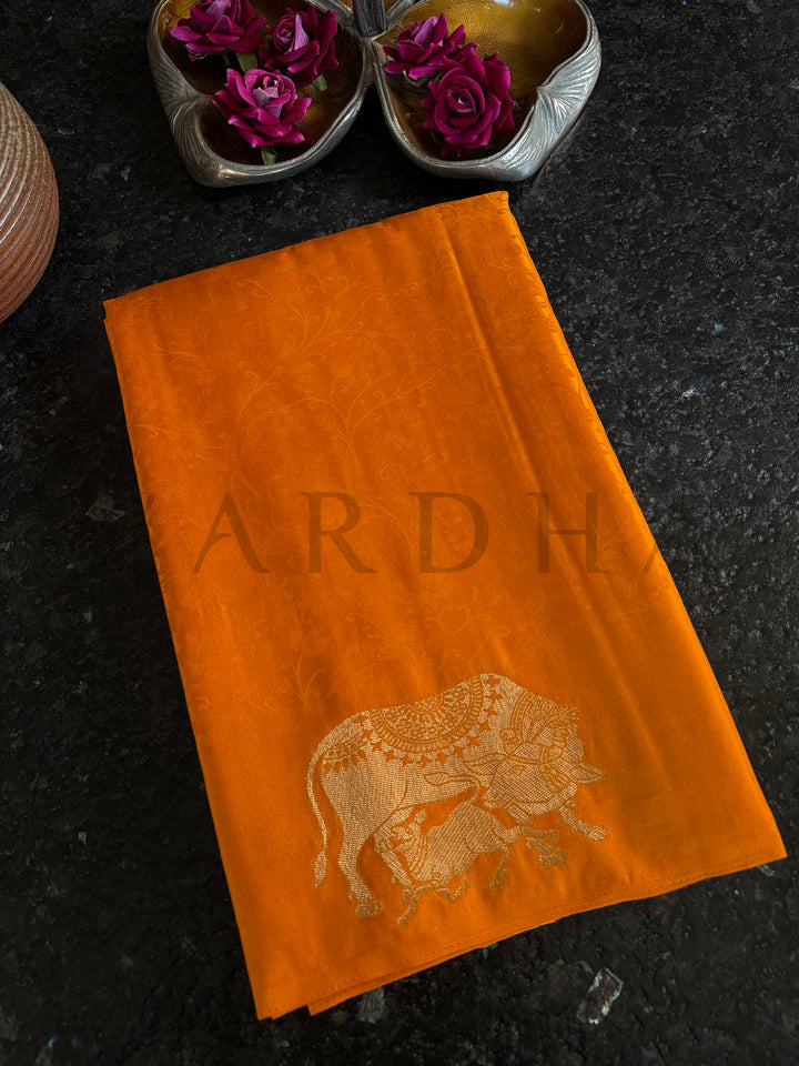 Glossy satin saree in ethnic orange with gold motifs – perfect for festive styling.

Trending mustard satin saree for women with detailed elephant zari pallu.