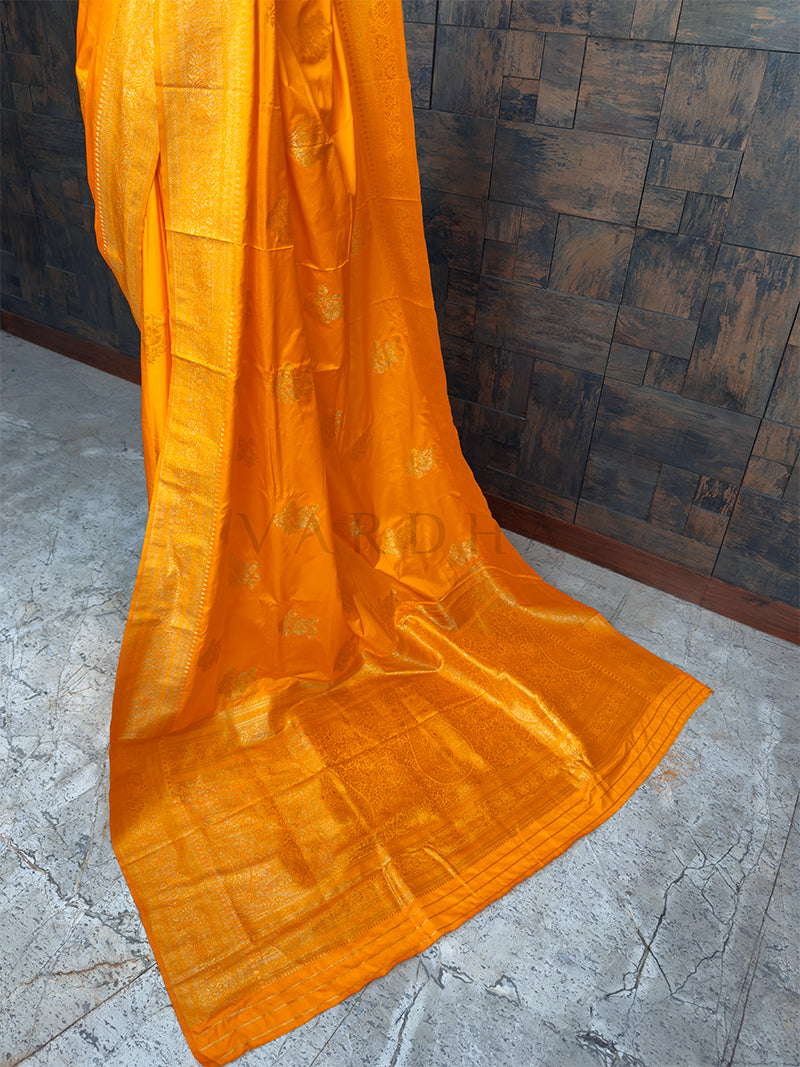Radiant Marigold Yellow festive satin saree from House of Vardha with heavy Antique Gold Zari work, perfect for Indian weddings and special occasions. We offer Ready to wear, Pre drape service, Saree Add on, Custom Stitched Blouse, Fall and Edging, Gift Packaging at Complimentary Price!