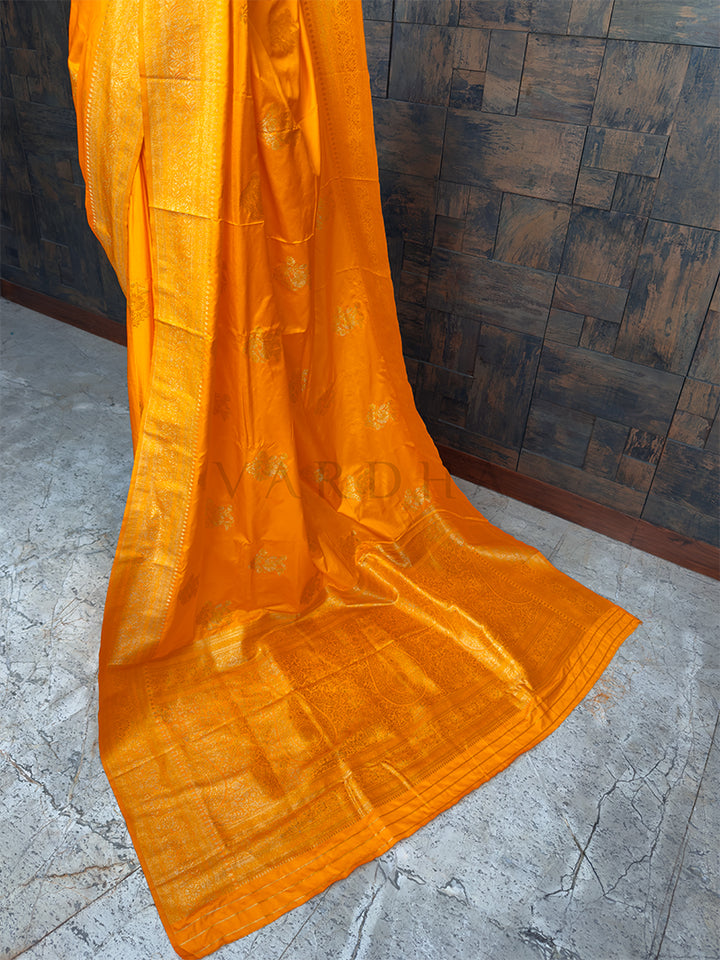 Radiant Marigold Yellow festive satin saree from House of Vardha with heavy Antique Gold Zari work, perfect for Indian weddings and special occasions. We offer Ready to wear, Pre drape service, Saree Add on, Custom Stitched Blouse, Fall and Edging, Gift Packaging at Complimentary Price!