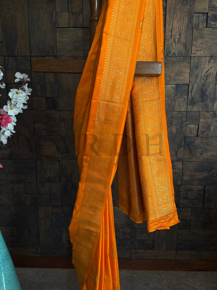 Authentic Indian ethnic wear featuring a striking Marigold Yellow Satin Saree richly woven with antique golden threads to create a festive look by House of Vardha. We offer Ready to wear, Pre drape service, Saree Add on, Custom Stitched Blouse, Fall and Edging, Gift Packaging at Complimentary Price!