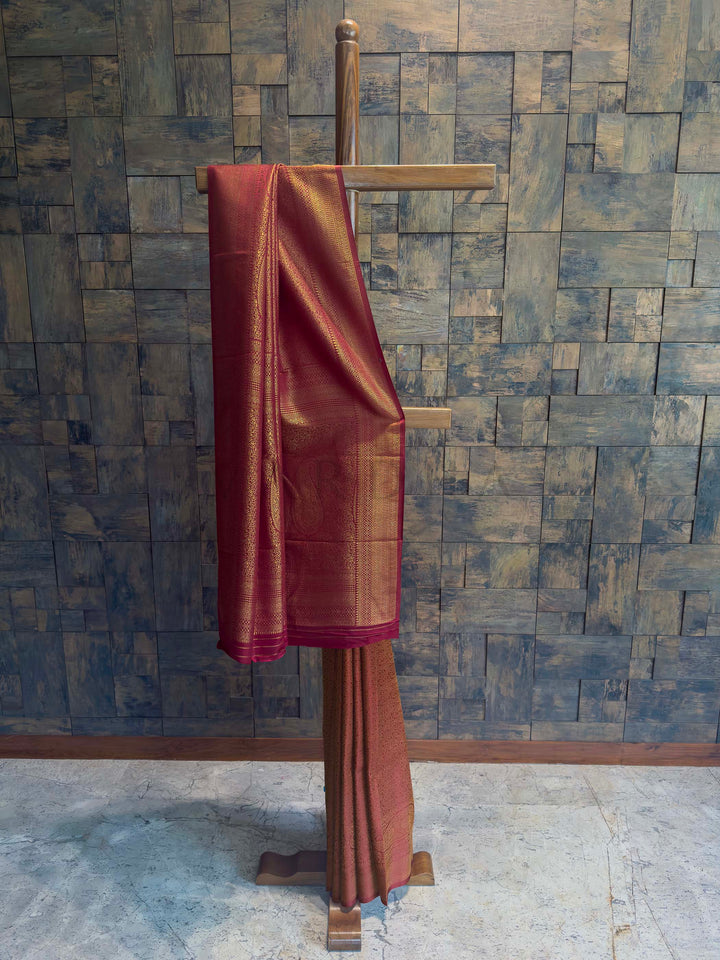 Maroon Golden Zari Kanjivaram Silk Saree House of Vardha. House of Vardha designer Maroon Golden Zari Kanjivaram Silk Saree featuring traditional golden zari buttis across the body and a heavy, decorative pallu. We offer Ready to wear, Pre drape service, Saree Add on, Custom Stitched Blouse, Fall and Edging, Gift Packaging at Complimentary Price!