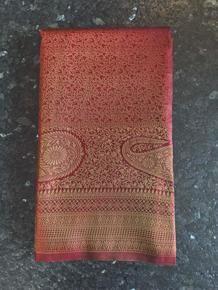 Maroon Golden Zari Kanjivaram Silk Saree House of Vardha. Beautifully draped Maroon Golden Zari Kanjivaram Silk Saree showcasing the elegant fall of the silk fabric and the glimmer of the golden zari by House of Vardha. We offer Ready to wear, Pre drape service, Saree Add on, Custom Stitched Blouse, Fall and Edging, Gift Packaging at Complimentary Price!