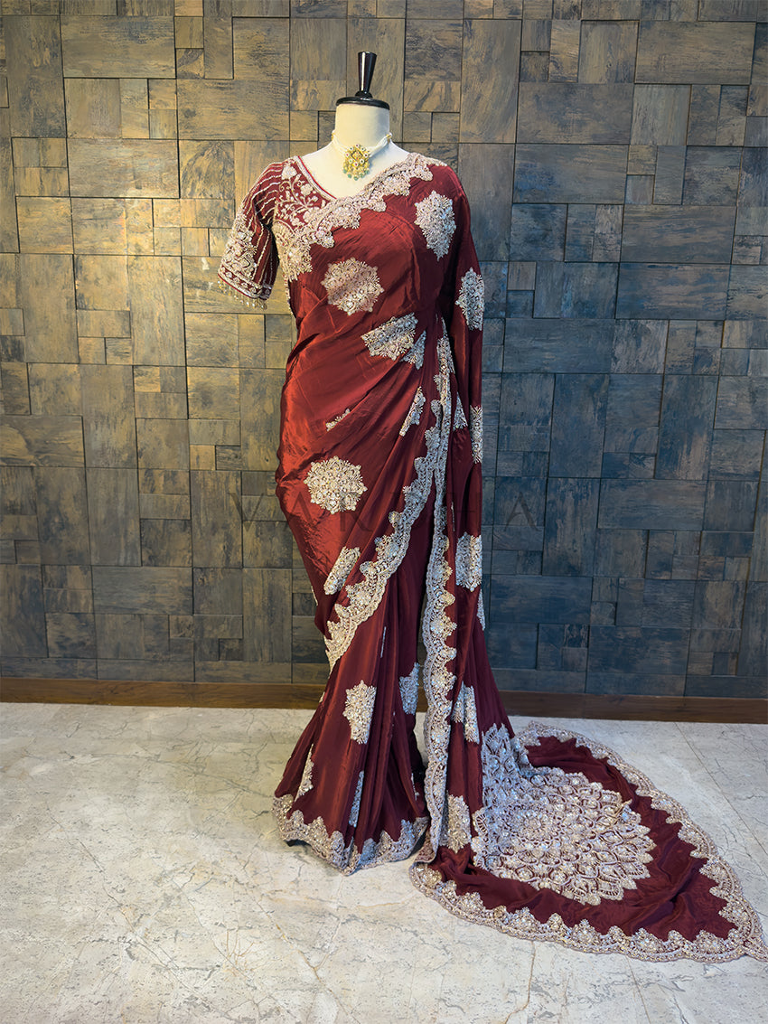 Full View Heavy Handwork Maroon Satin Crepe Saree for Receptions. House of Vardha Maroon Satin Crepe Saree featuring intricate Silver Cutdana and Beads Handwork, elegantly draped on a mannequin. We offer Ready to wear, Pre drape service, Saree Add on, Custom Stitched Blouse, Fall and Edging, Gift Packaging at Complimentary Price!

