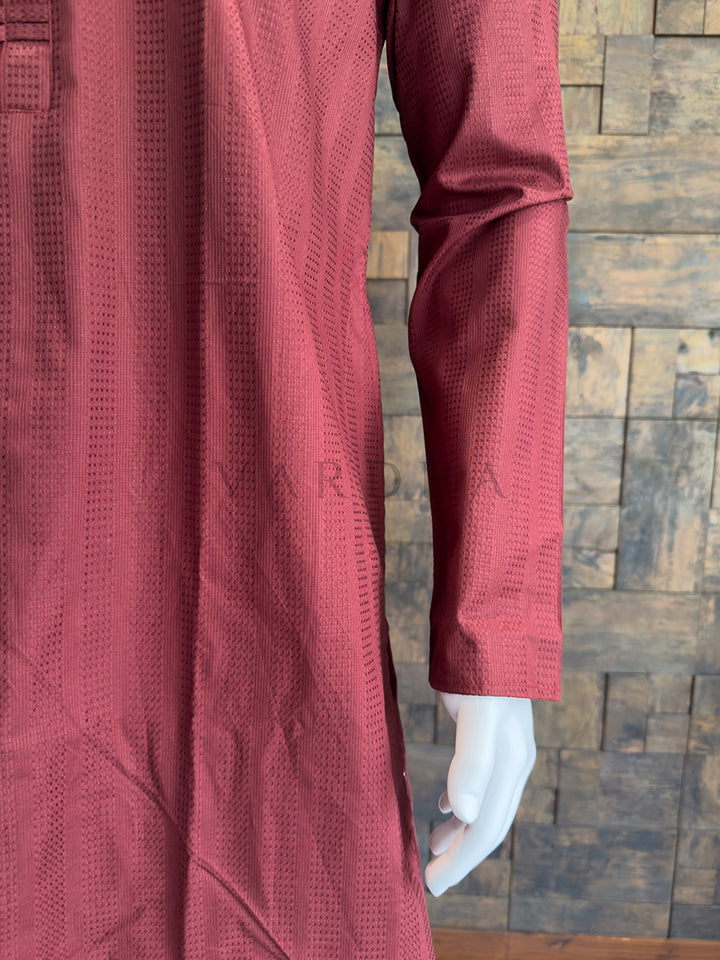 Maroon textured garment on a mannequin against a wooden paneled wall. Detailed view of a Maroon cotton kurta chest highlighting the contemporary contrast between the rich burgundy fabric and high-shine silver buttons.