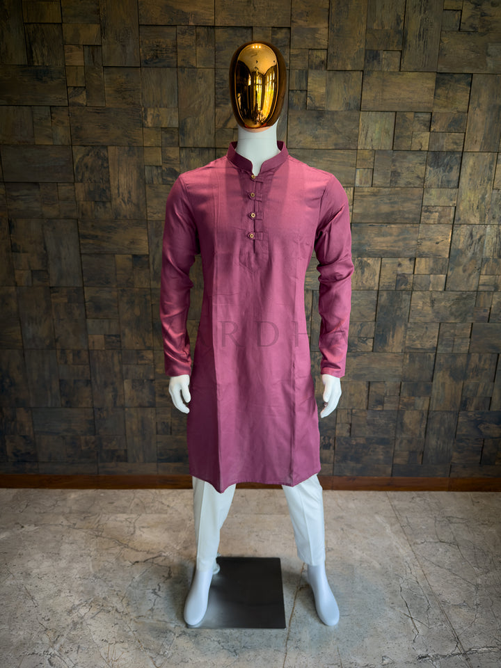 Mannequin wearing a maroon kurta with a gold mask against a wooden paneled wall. Modern minimalist ethnic wear: A Mauve Pink cotton kurta with a distinct micro-check pattern that provides visual depth and a crisp, structured drape.