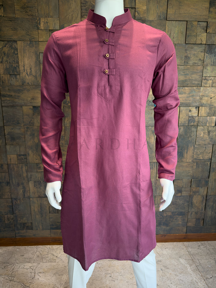 Mauve kurta on a mannequin against a wooden paneled wall. Mauve Pink Designer Cotton Kurta for Men - Micro-Check Textured Festive Wear with Wooden Buttons.