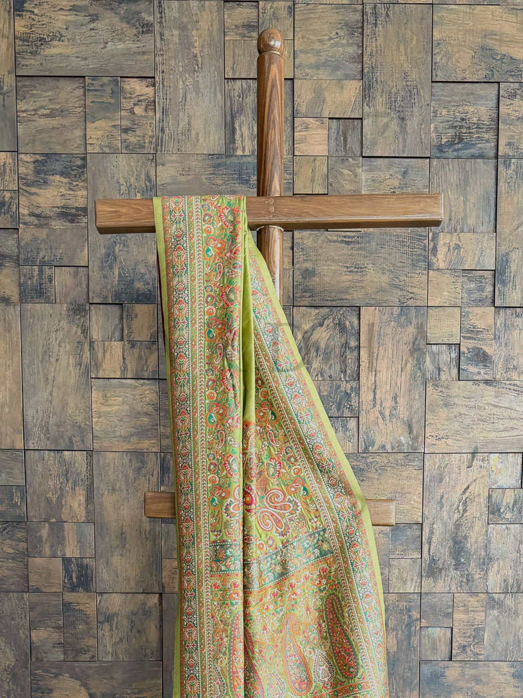 Mehendi green raw silk saree with a soft Pashmina finish and intricate embossed thread work, perfect for festive occasions.