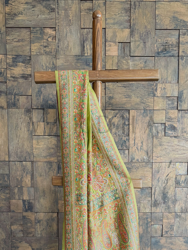 Mehendi green raw silk saree with a soft Pashmina finish and intricate embossed thread work, perfect for festive occasions.