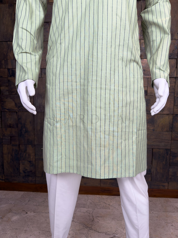 Green pinstripe kurta on a mannequin against a wooden paneled wall.