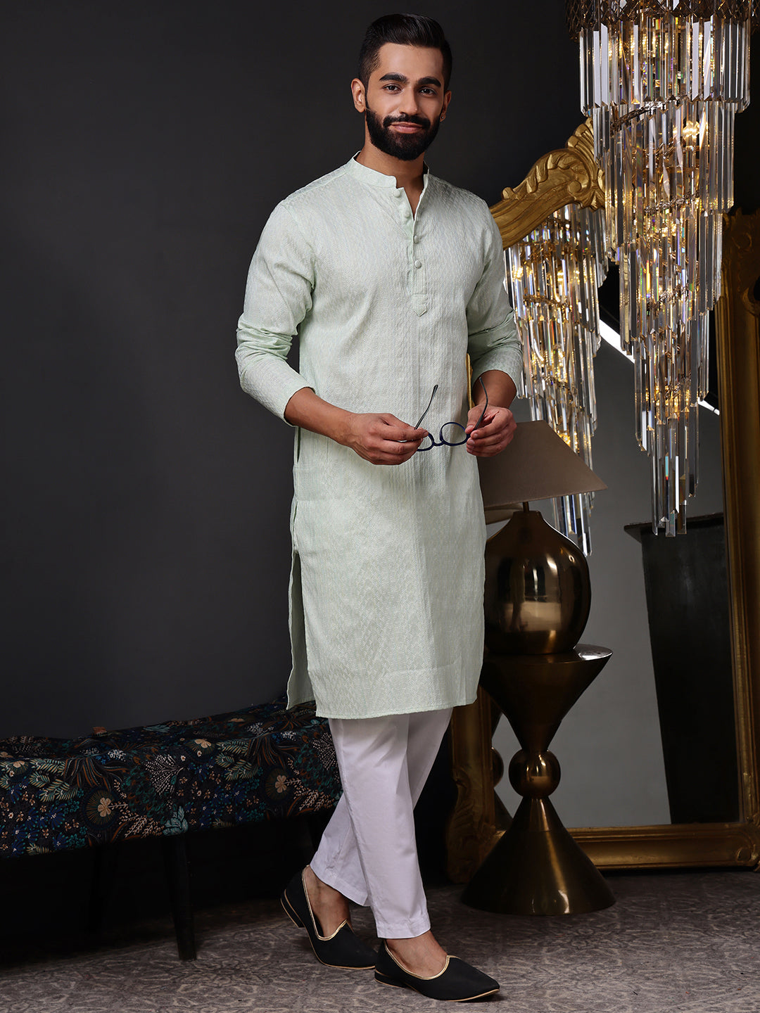 Full view of a model wearing a crisp mint green textured kurta with white pajamas

